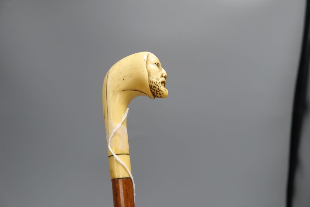 A Druids head carved cane, c.1860, length 85cm